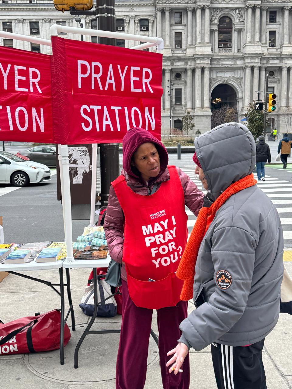 A Prayer Station volunteer listening to a visitor near City Hall